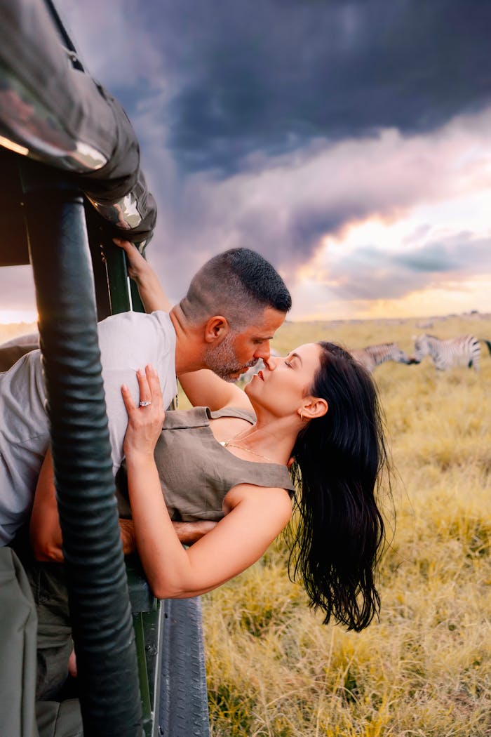 hero-img-01 Romantic couple kissing during a safari adventure in Nairobi, Kenya.