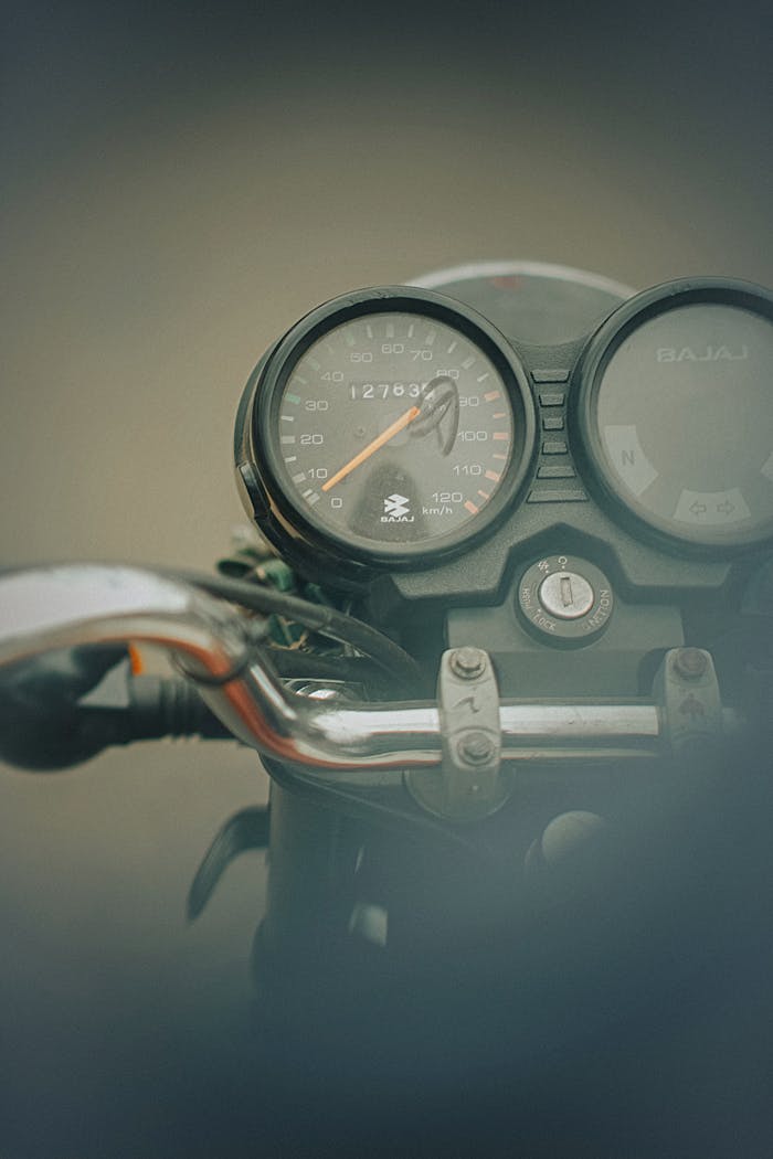 gallery-6 Close-up of a vintage motorcycle speedometer with retro design in Ibadan, Nigeria.